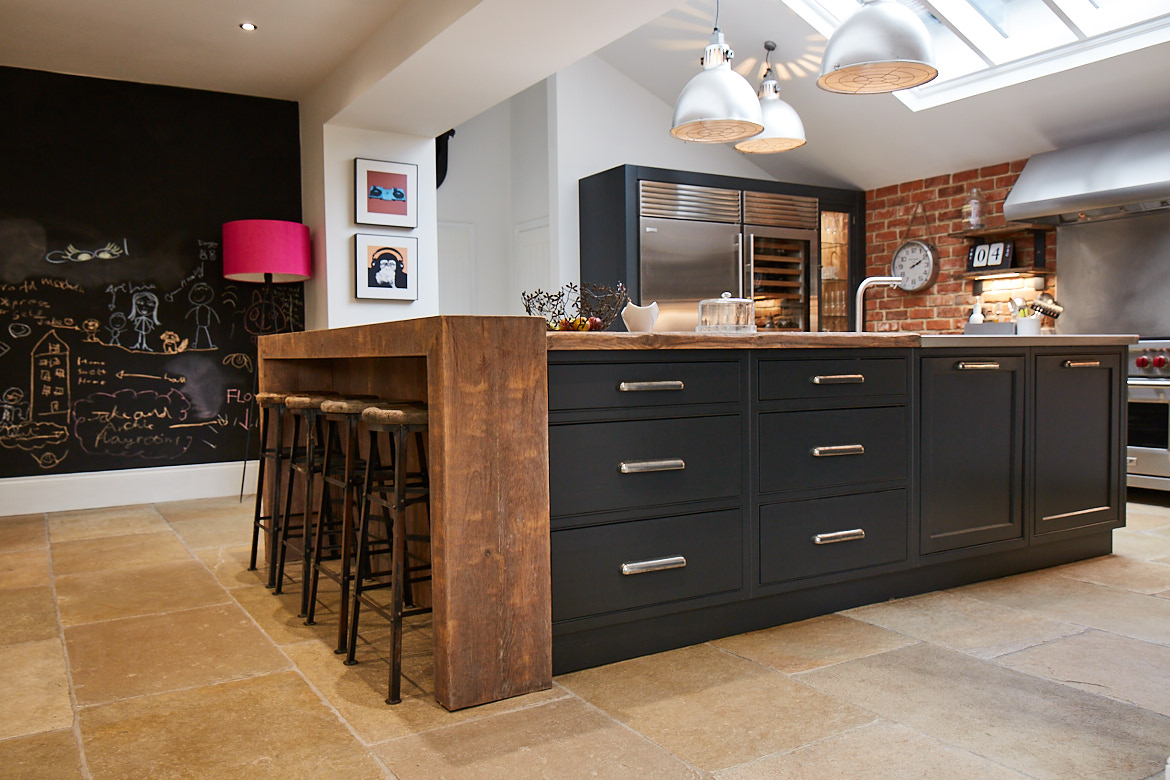 Bespoke kitchen island by The Main Company with reclaimed oak chunky breakfast bar wrap around and rich and deep painted cabinets