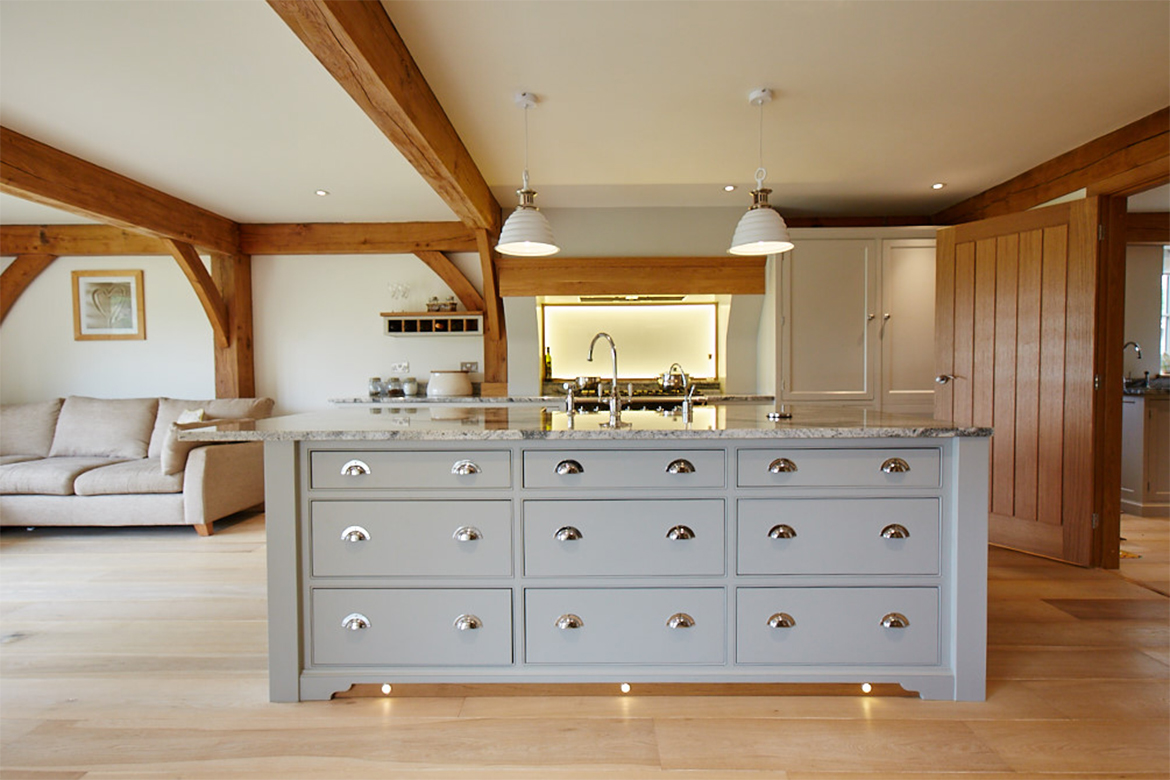 A bank of three drawer stacks make up the bespoke kitchen island with two pendant lights above