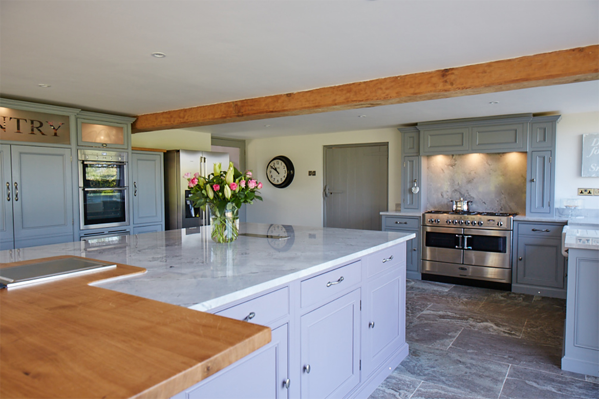 Combination of solid oak and granite worktops sat on bespoke kitchen units