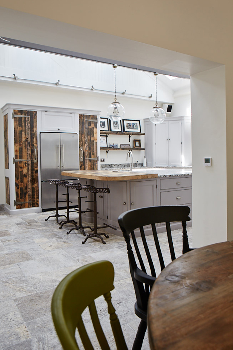 Vintage kitchen table and chair with bespoke kitchen behind