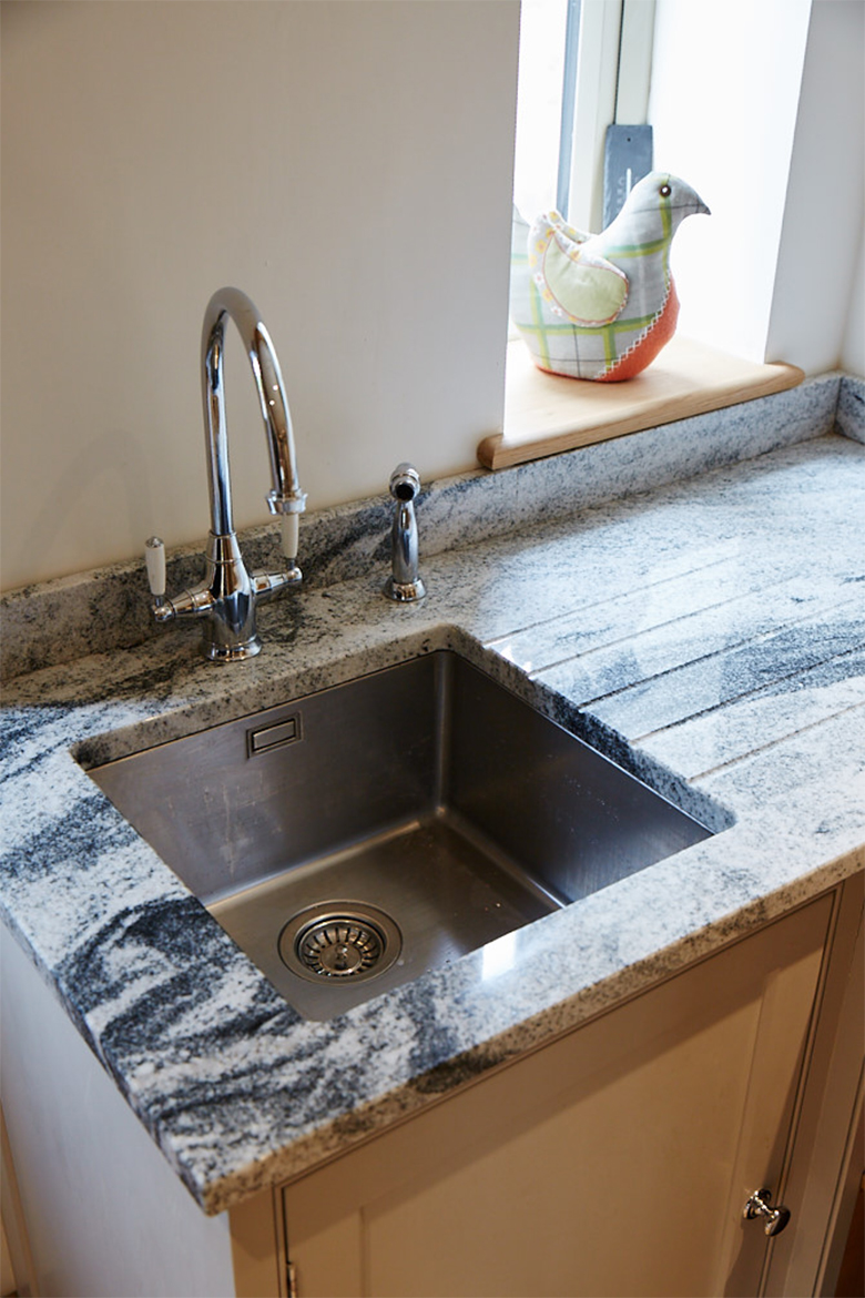 Inset stainless steel sink with granite worktops and chrome mono tap