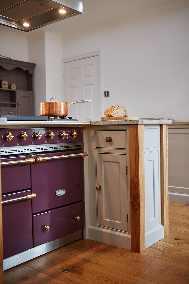 Copper pan sits on top of classic plum lacanche macon with brass trim