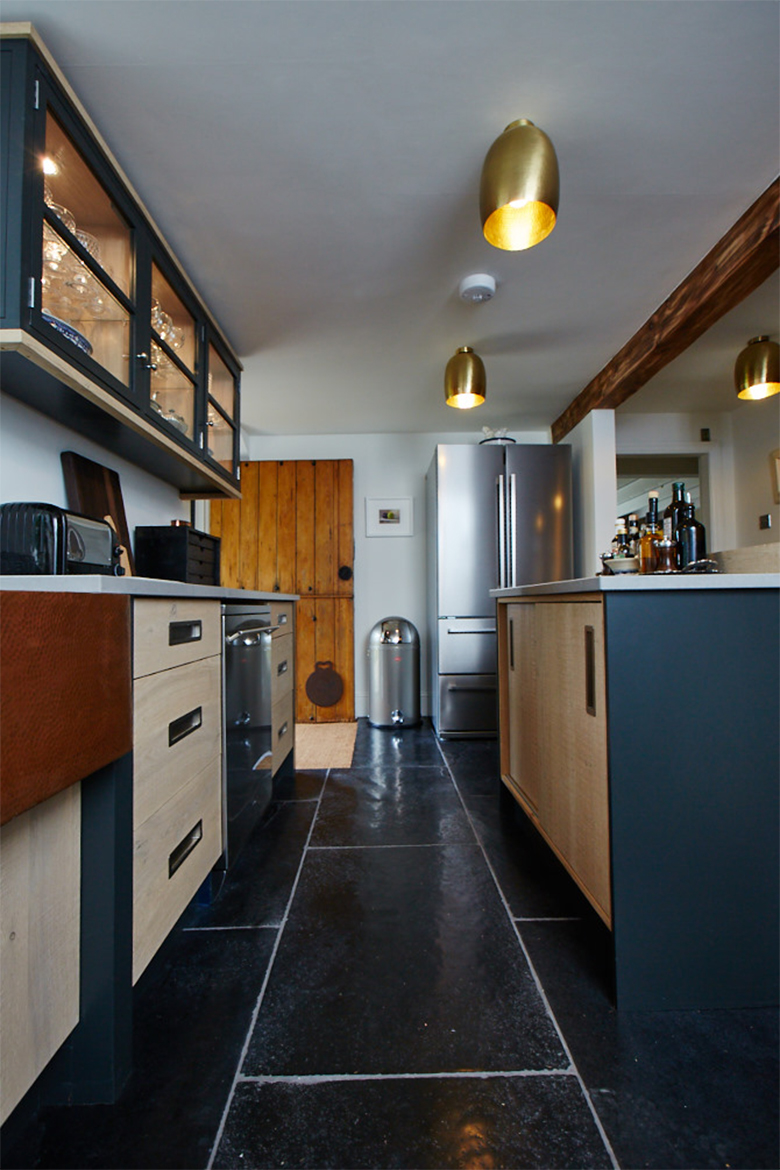 Black slate tiles with the bespoke oak kitchen units on top