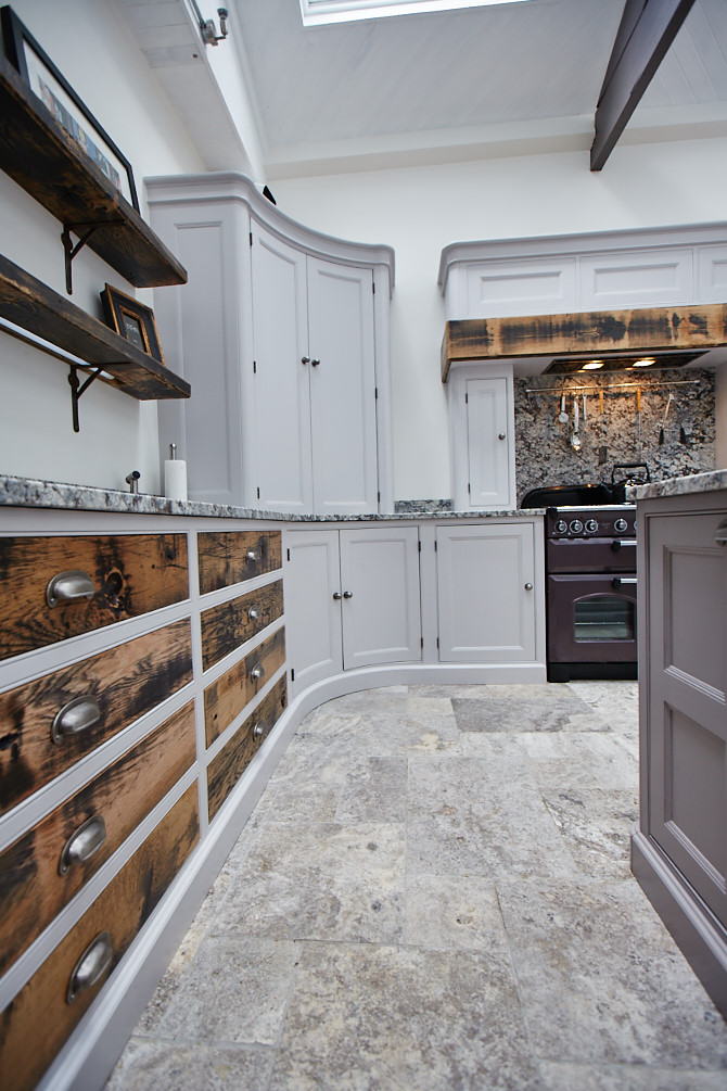 Close up of reclaimed oak drawer fronts set in to painted cabinet frames