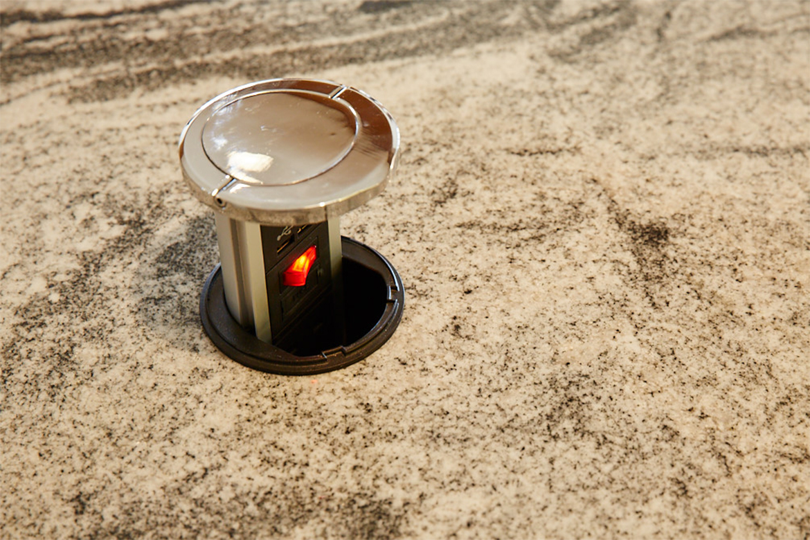 Hafele pop up socket with chrome detail integrated into granite worktop