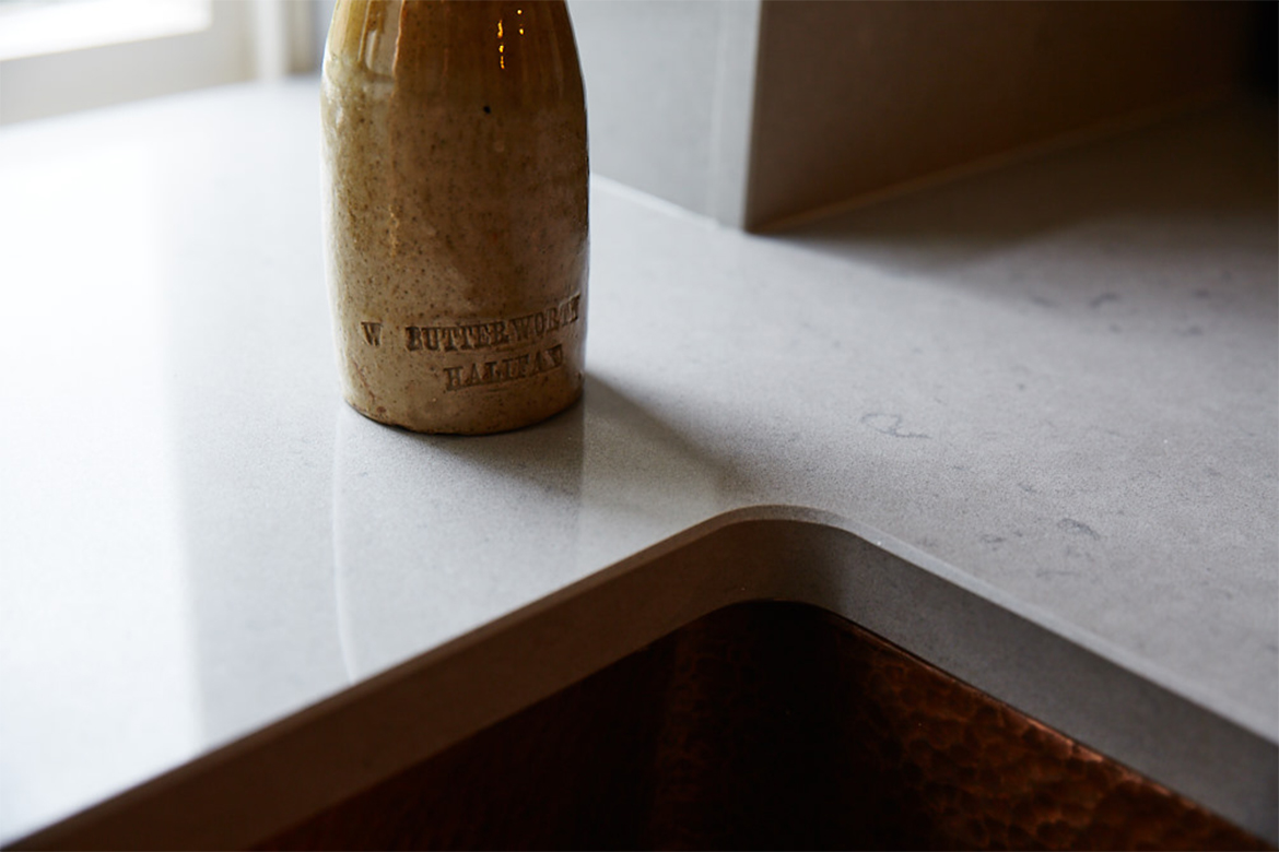 Bottle sat on bespoke grey caesarstone quartz worktops