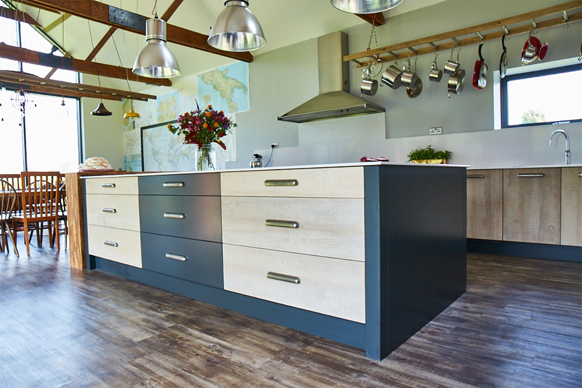 Two tone kitchen island drawers with white wash rustic reclaimed oak and painted little greene drawers fronts finished with finesse pewter handle