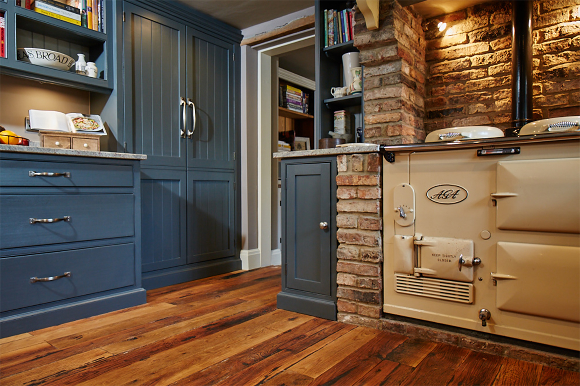 Closed tall integrated kitchen units painted deep blue farrow and ball with croft handles and T&G panels