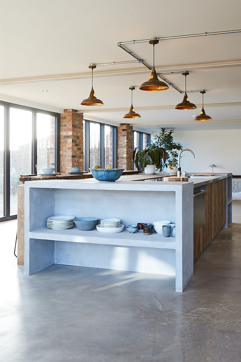 Porcelain sits on light grey concrete bespoke kitchen island bookcase