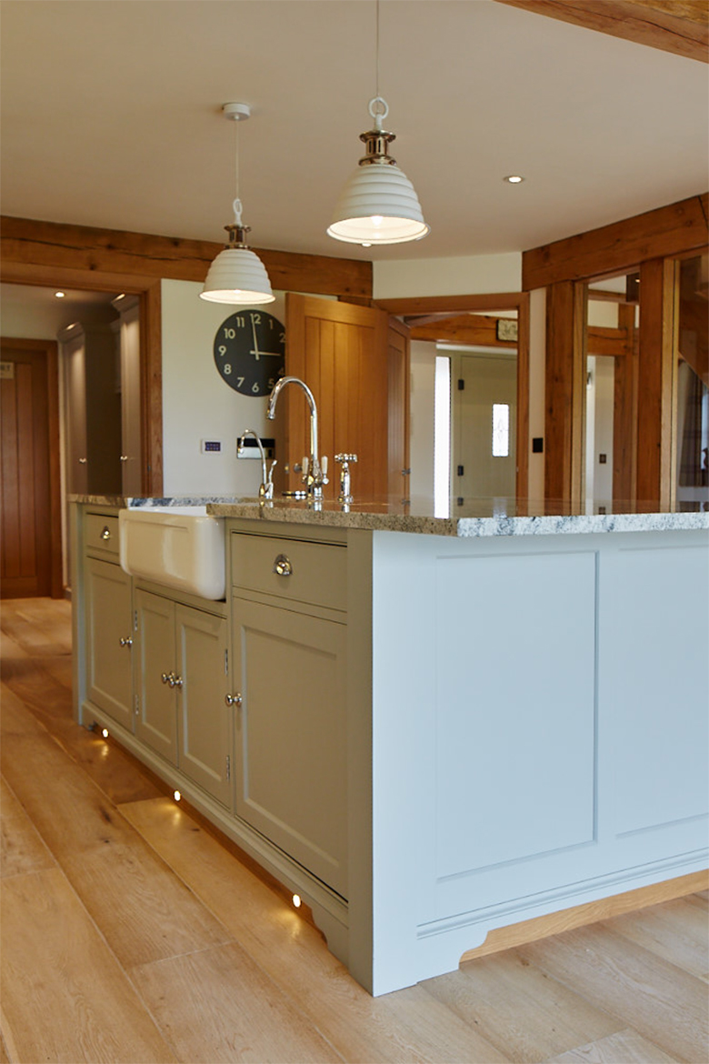 Painted kitchen island with pendant lights above Shaws belfast sink