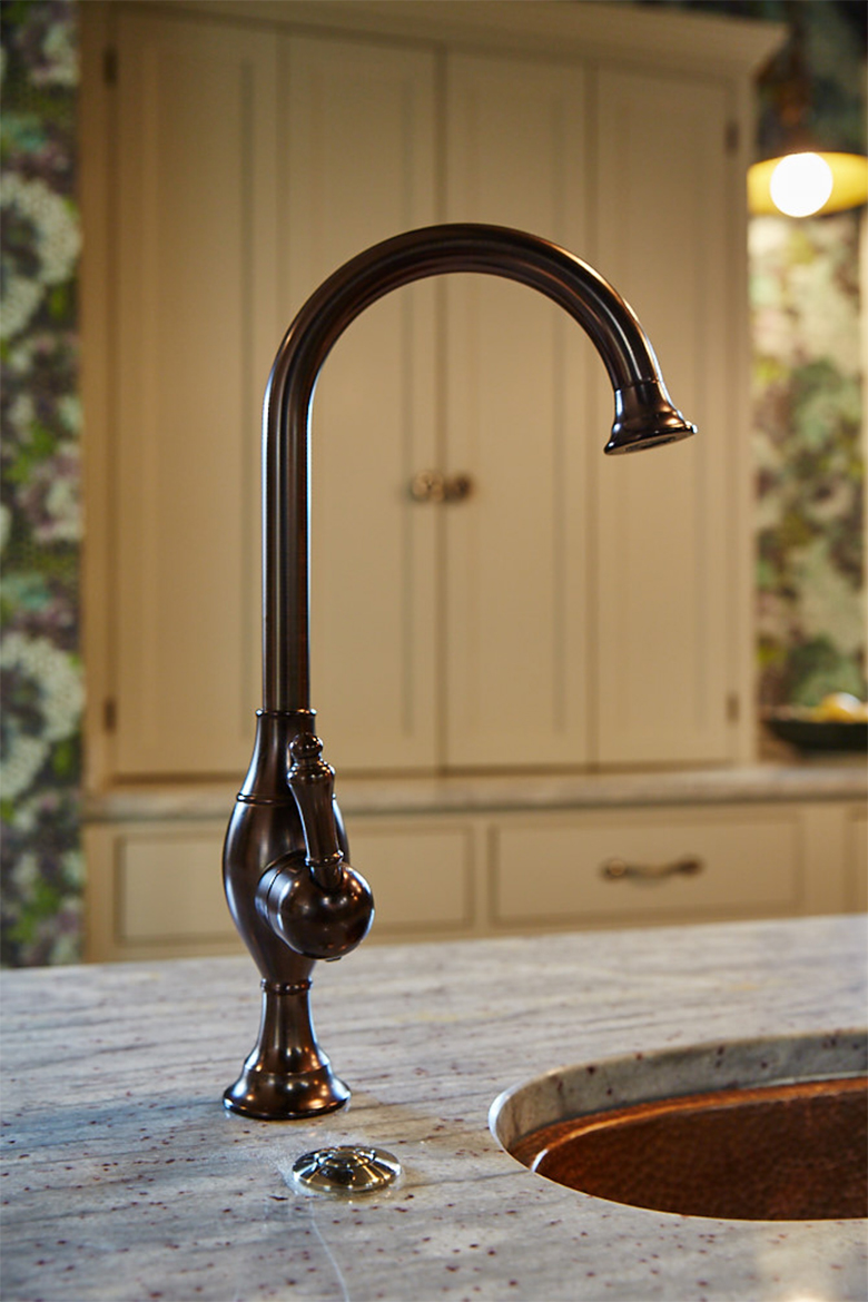 Antique aged copper hot boiling tap sits on solid bespoke granite worktops