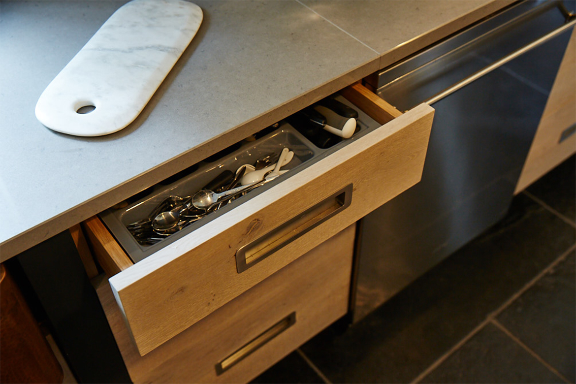 Bespoke engineered kitchen drawer stack with utensil insert and caesarstone worktop