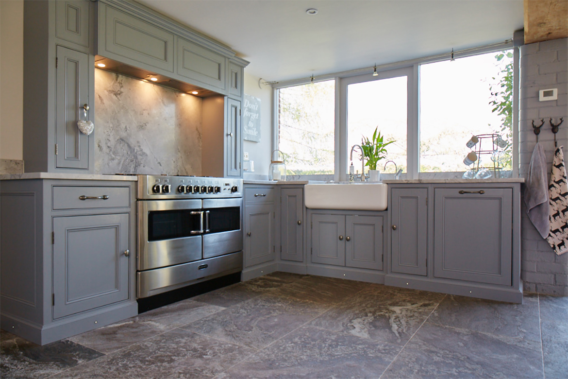 Traditional painted bespoke mantle over stainless steel range cooker with ceramic belfast sink in l shape configuration