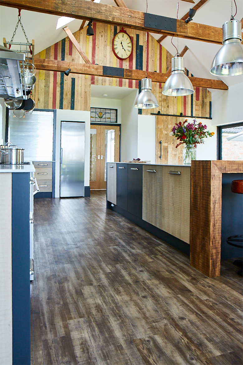 Reclaimed rustic on frame slab kitchen units with reclaimed cladded wall