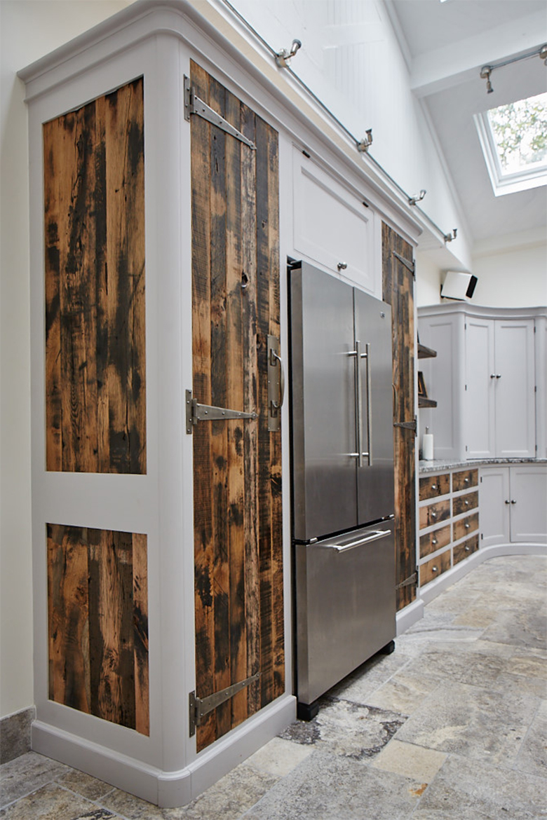 Semi integrated stainless fridge freezer with bespoke reclaimed oak kitchen cabinets