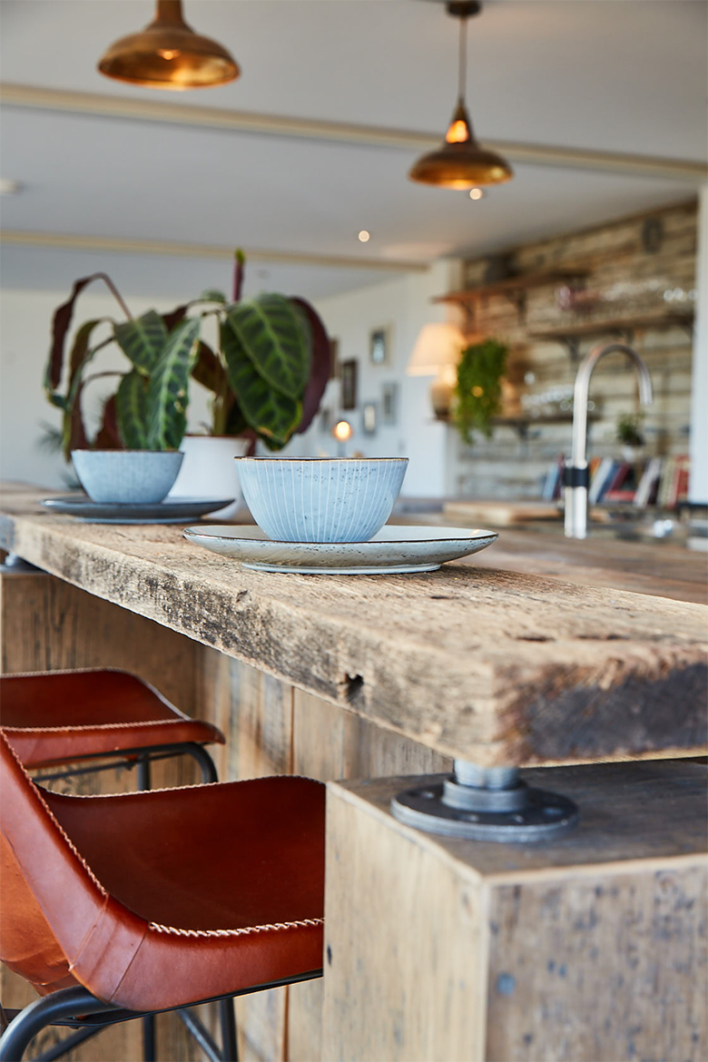 Chunky reclaimed oak rustic breakfast bar with blue mug and saucer