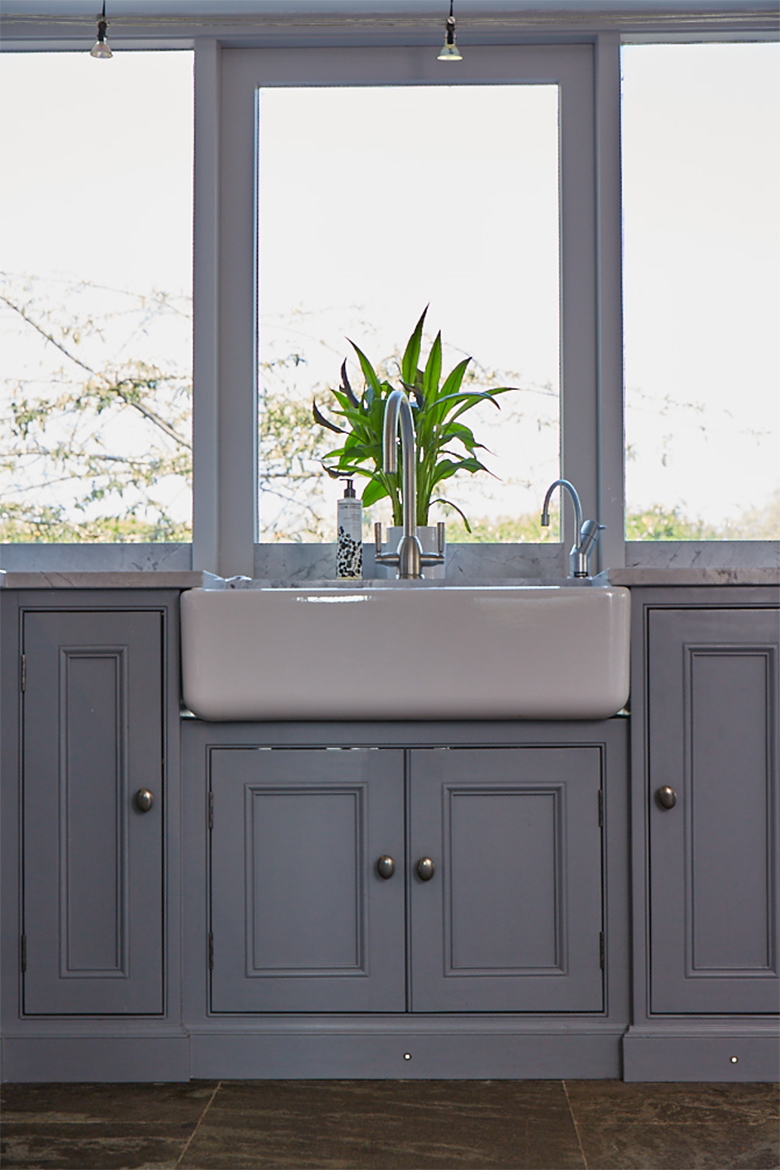 Shaws ceramic double belfast sink and brushed nickel tap sits on painted bespoke cabinet