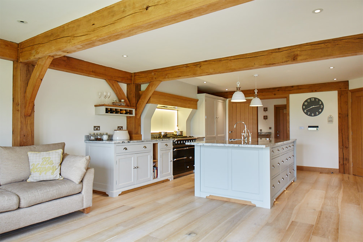 Bespoke kitchen island with granite worktop and false chimney breast