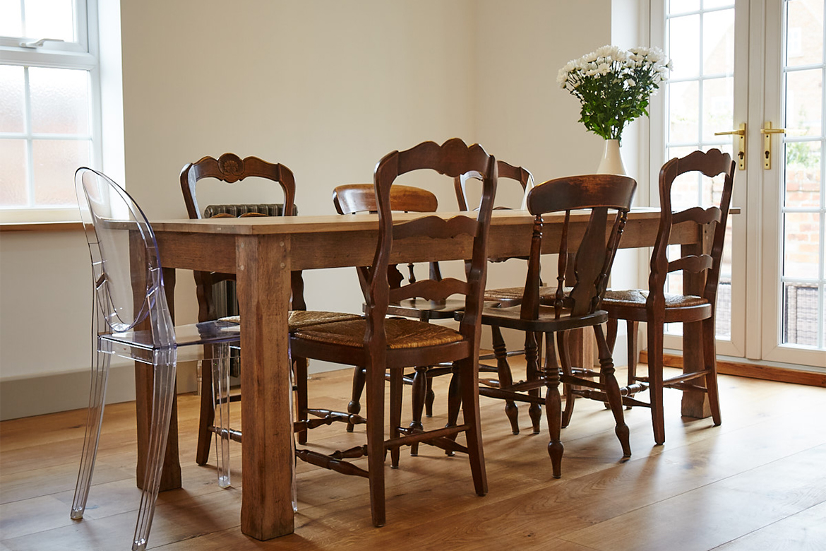 Reclaimed kitchen dining table with eclectic mix of dining chairs