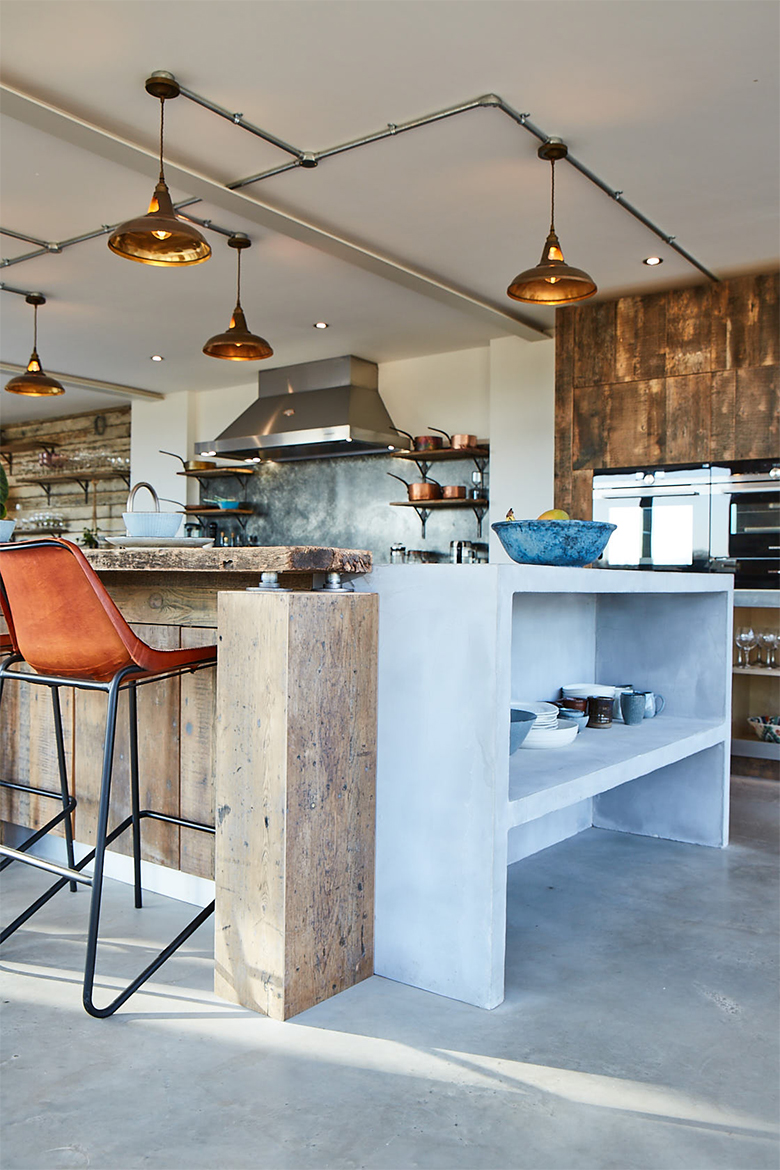 Reclaimed pine wood against grey washed bespoke kitchen concrete island end