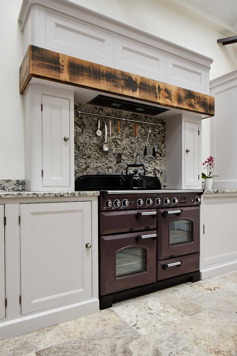 Deep purple range cooker with bespoke reclaimed oak mantle and canopy