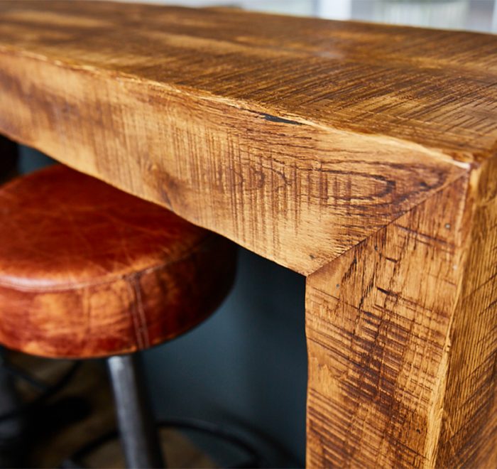 Reclaimed wood wrap around breakfast bar with leather bar stools