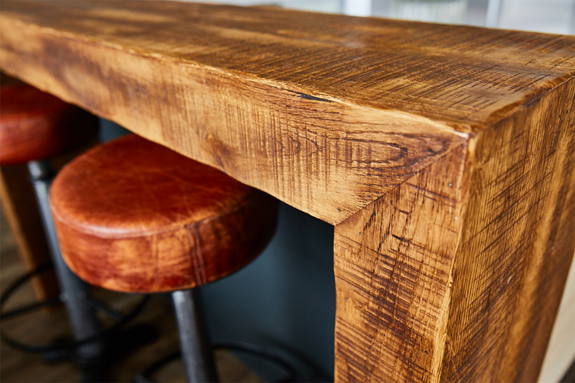 Reclaimed wood wrap around breakfast bar with leather bar stools