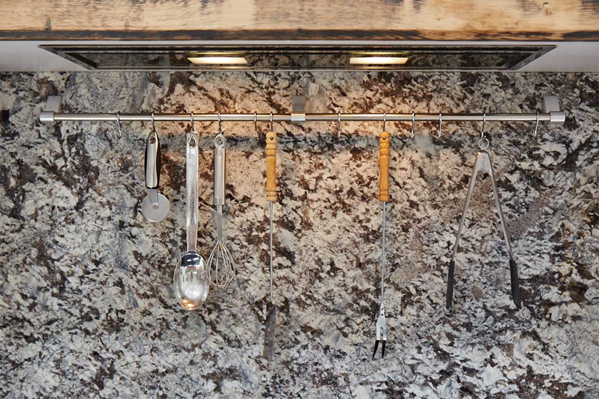 Kitchen utensil rack with granite backsplash