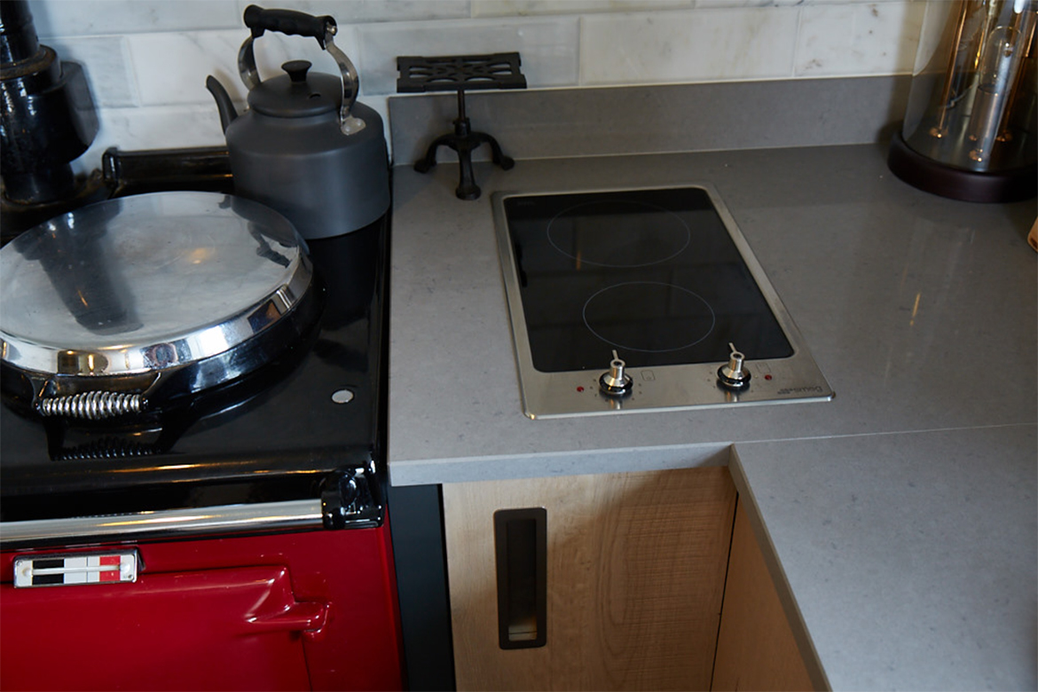 Domino hob sits on top of caesarstone worktop next to reg AGA