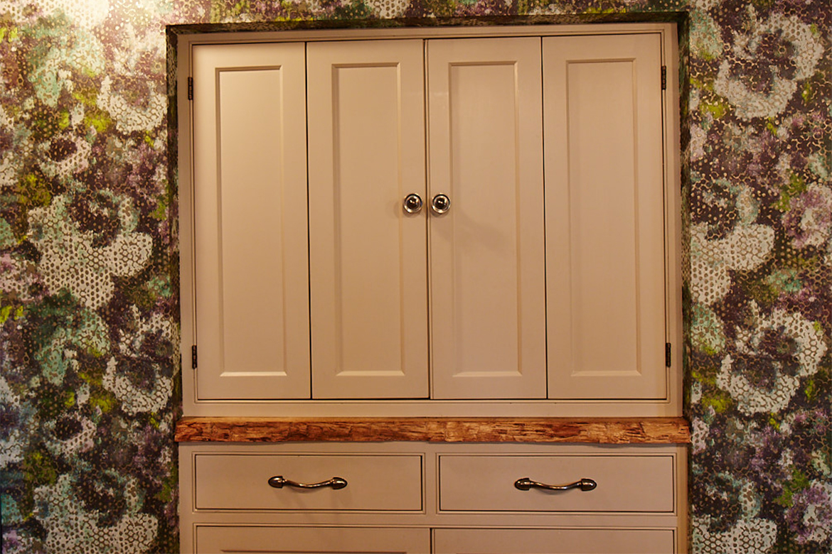 Painted bespoke bi fold unit with pewter Finesse handles and reclaimed oak rustic worktop