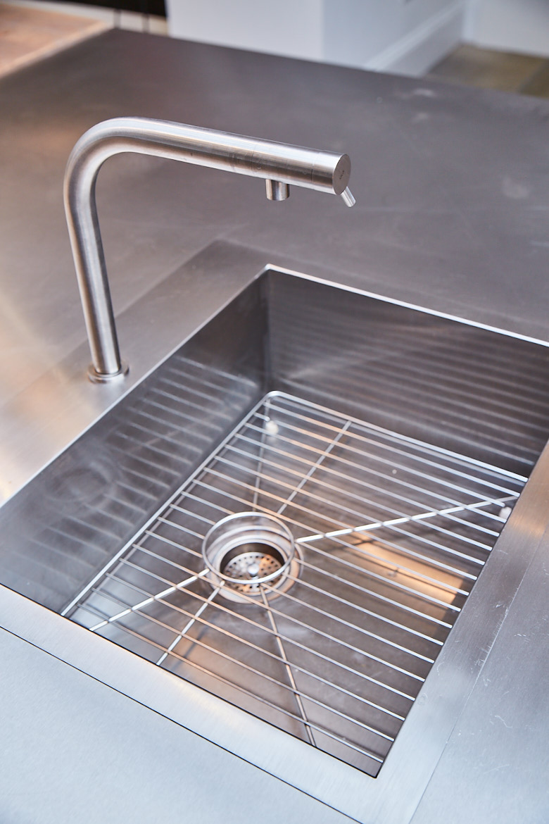Stainless steel kholer sink with matching modern mono tap overmount on bespoke stainless steel worktop