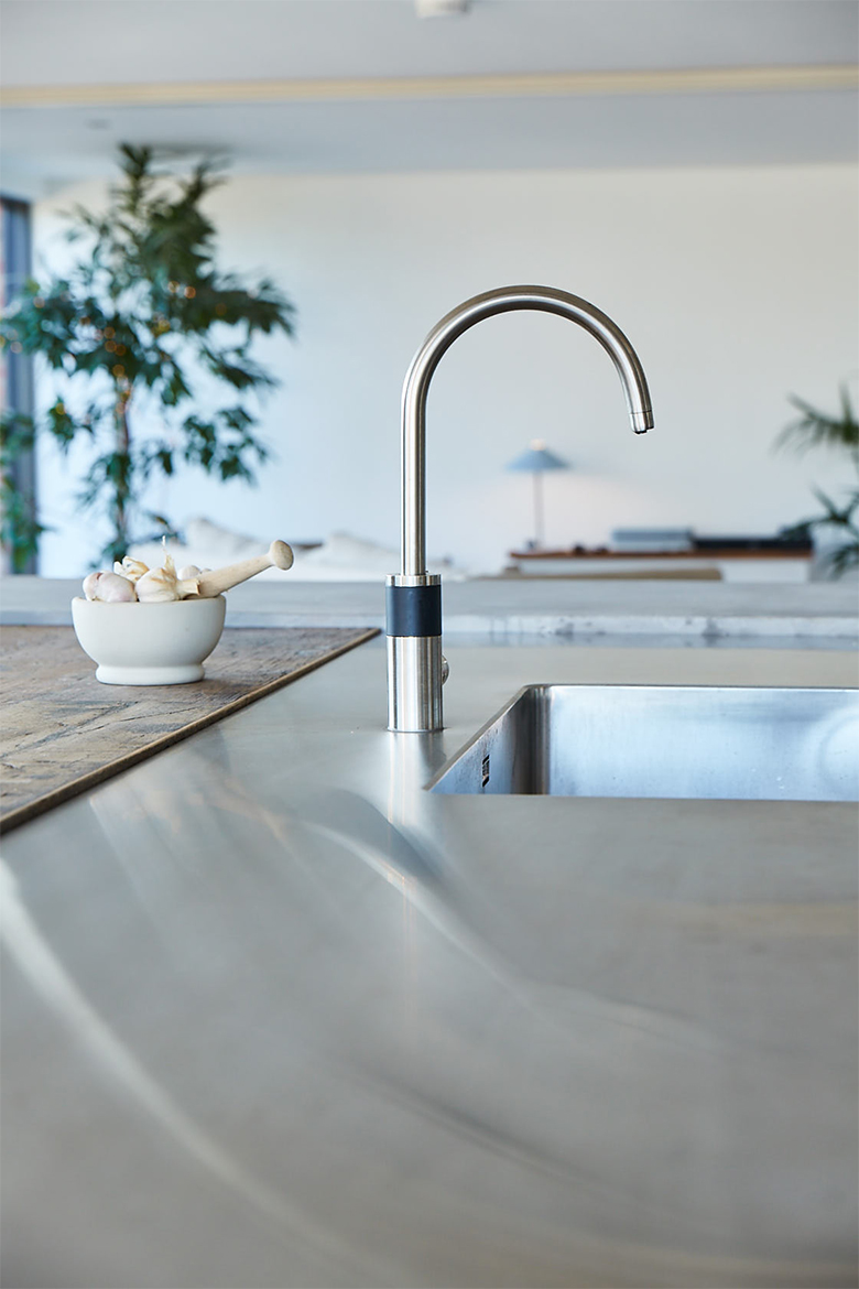 Seamless stainless steel bespoke worktop with Abobe stainless steel mono tap