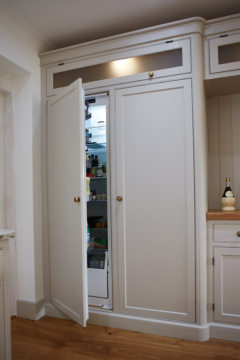 Integrated siemens larder fridge in a painted bespoke kitchen cabinet with glass top box
