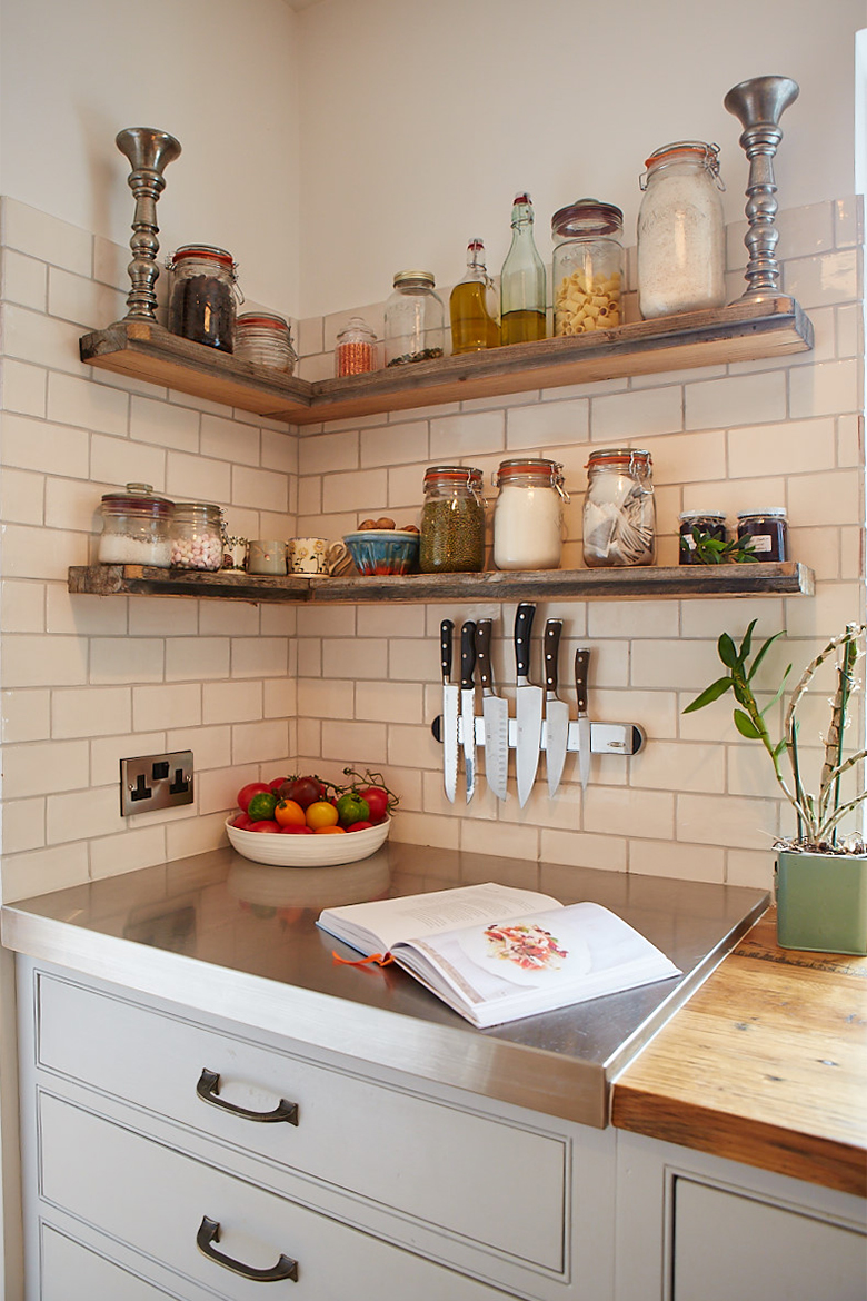 Reclaimed oak shelves floating against white metro tiles with stainless steel worktop below on bespoke kitchen cabinet
