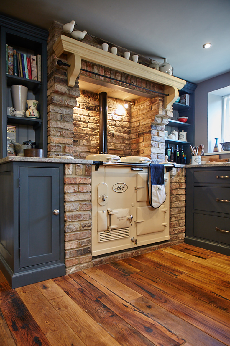Original cream AGA in exposed brick fireplace and painted mantle