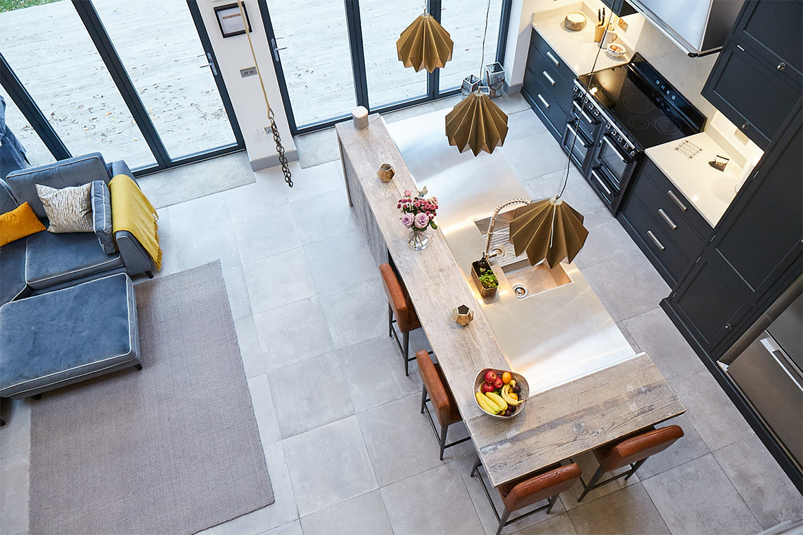 Ariel shot of kitchen island with reclaimed wrap around wood breakfast bar and stainless steel worktop