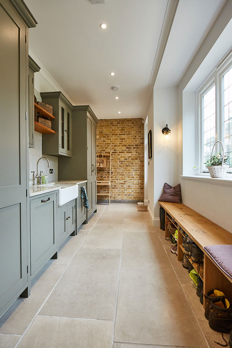 Utility with exposed yellow London brick wall, belfast sink and solid oak shoe storage