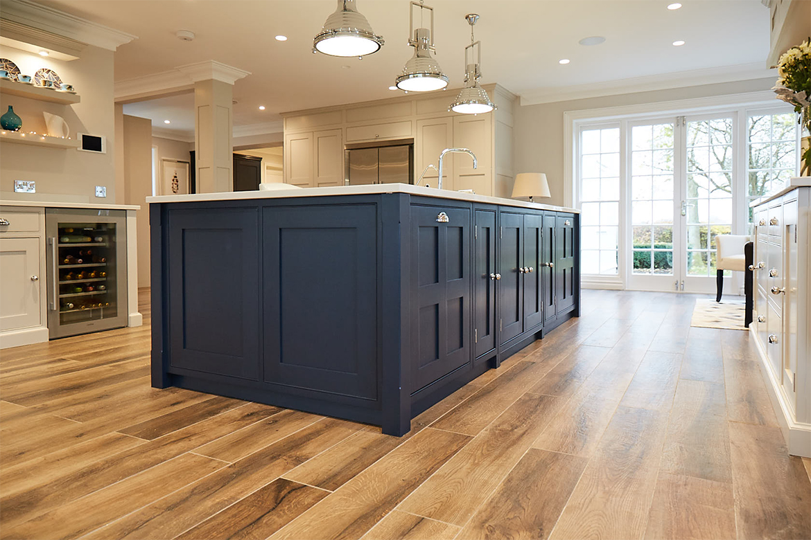 Wood floor with Little Greene blue painted kitchen island and Centaurus grey granite worktop