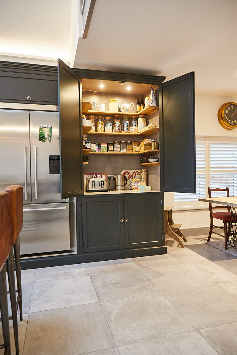 Larder unit filled with mixing goods and prep area with white quartz worktop