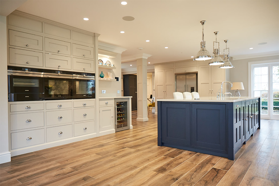 Tall oven stack with drawers below and lift up cupboard above painted in Little Greene light grey