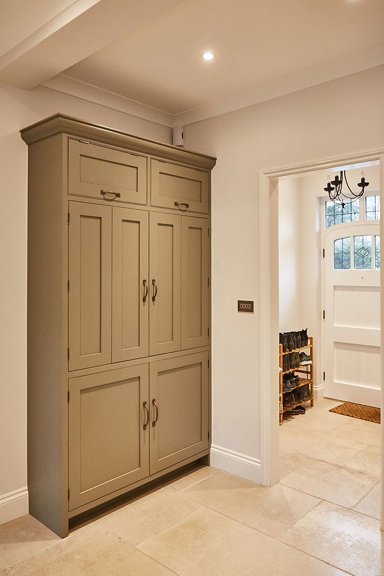 Single traditional bi-fold tall unit next to front door