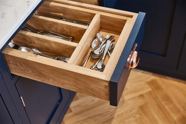 Top drawer of kitchen unit with bespoke solid oak insert to separate cutlery