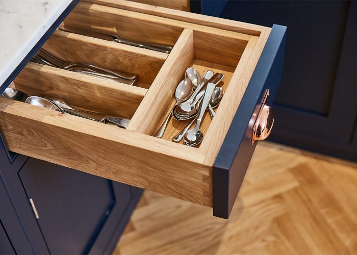 Top drawer of kitchen unit with bespoke solid oak insert to separate cutlery