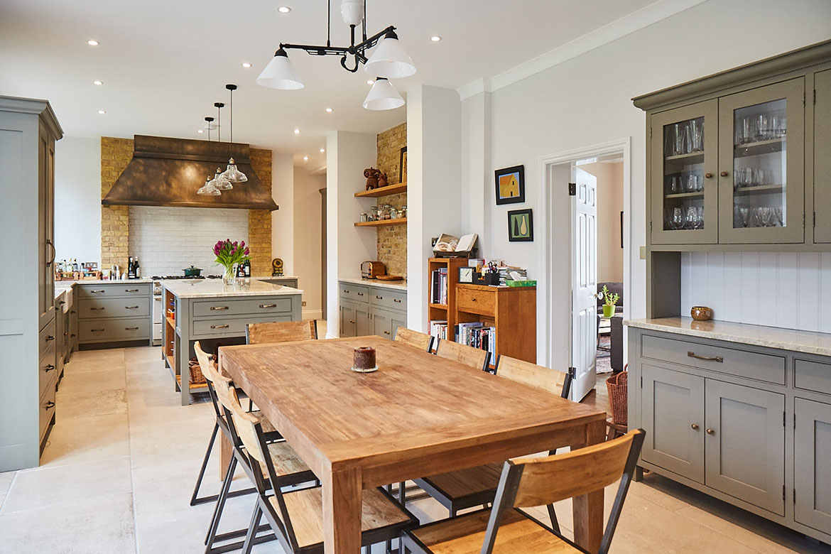 Rustic wood table and chairs with metal frame in open plan traditional London kitchen