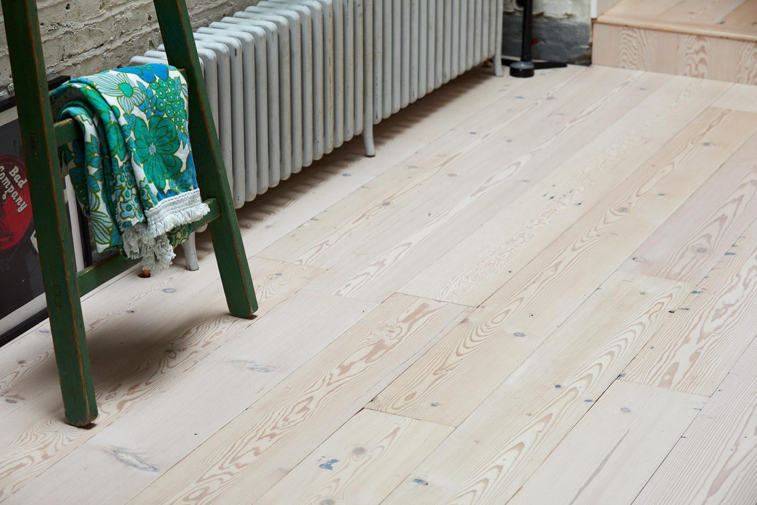 Whitewash pine flooring with green ladder