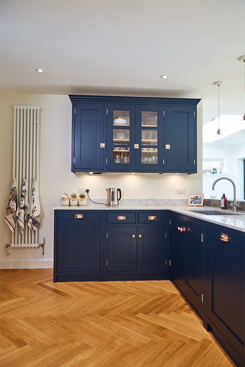 Bespoke painted wall cabinets with glass double doors in centre painted in basalt by Little Greene