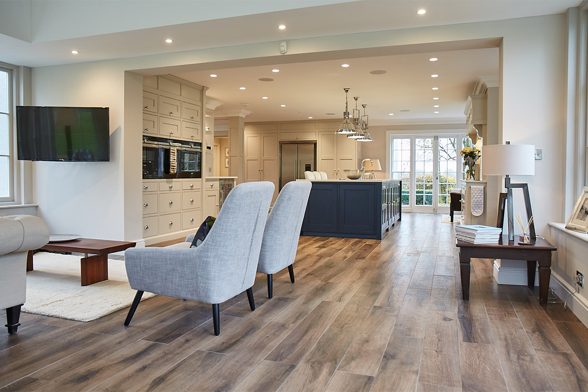 Occasional grey upholstered chairs in open plan kitchen