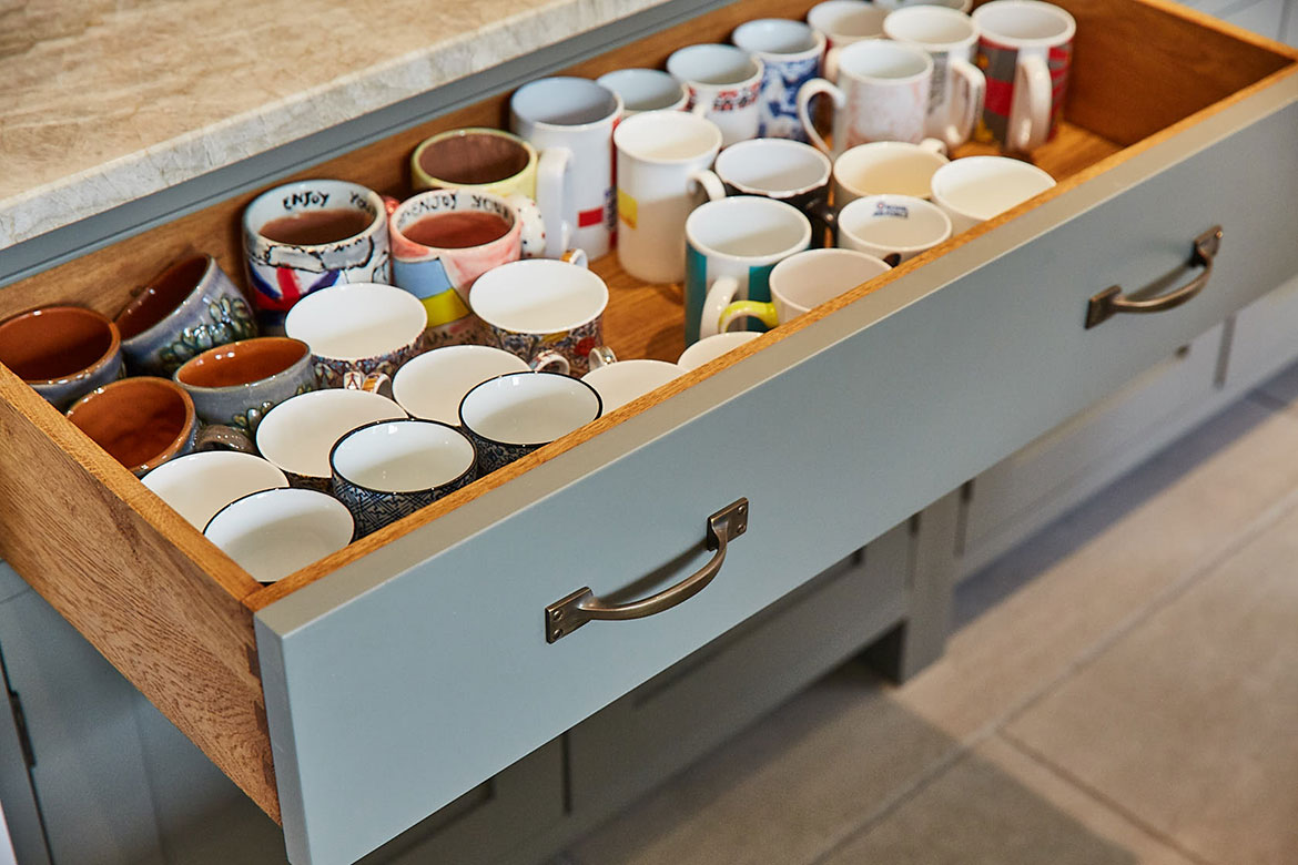 Solid oak drawer pox with painted front holds collection of mugs in pot board