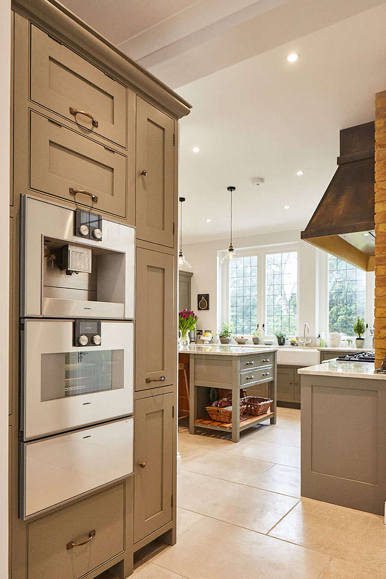 Gaggenau coffee machine, oven and warming drawer at eye level in grey moss Little Greene bespoke cabinets