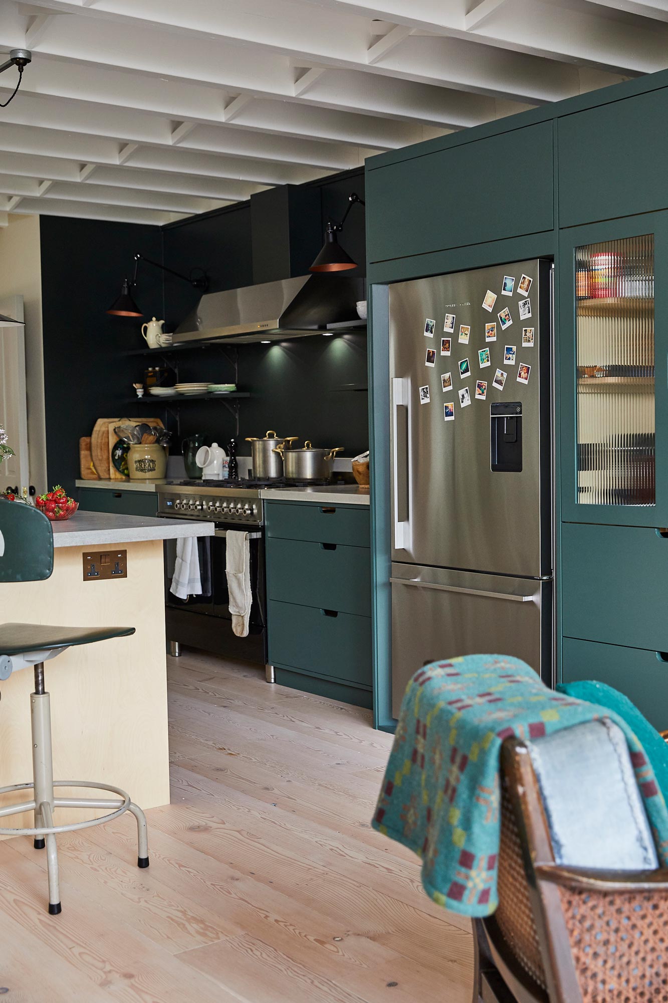 Freestanding stainless steel Fisher & Paykel fridge freezer in bespoke green kitchen